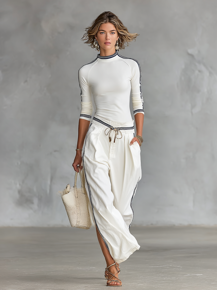 Completo da donna: T-shirt sportiva a maniche lunghe con collo alto e pantaloni larghi con cordoncino